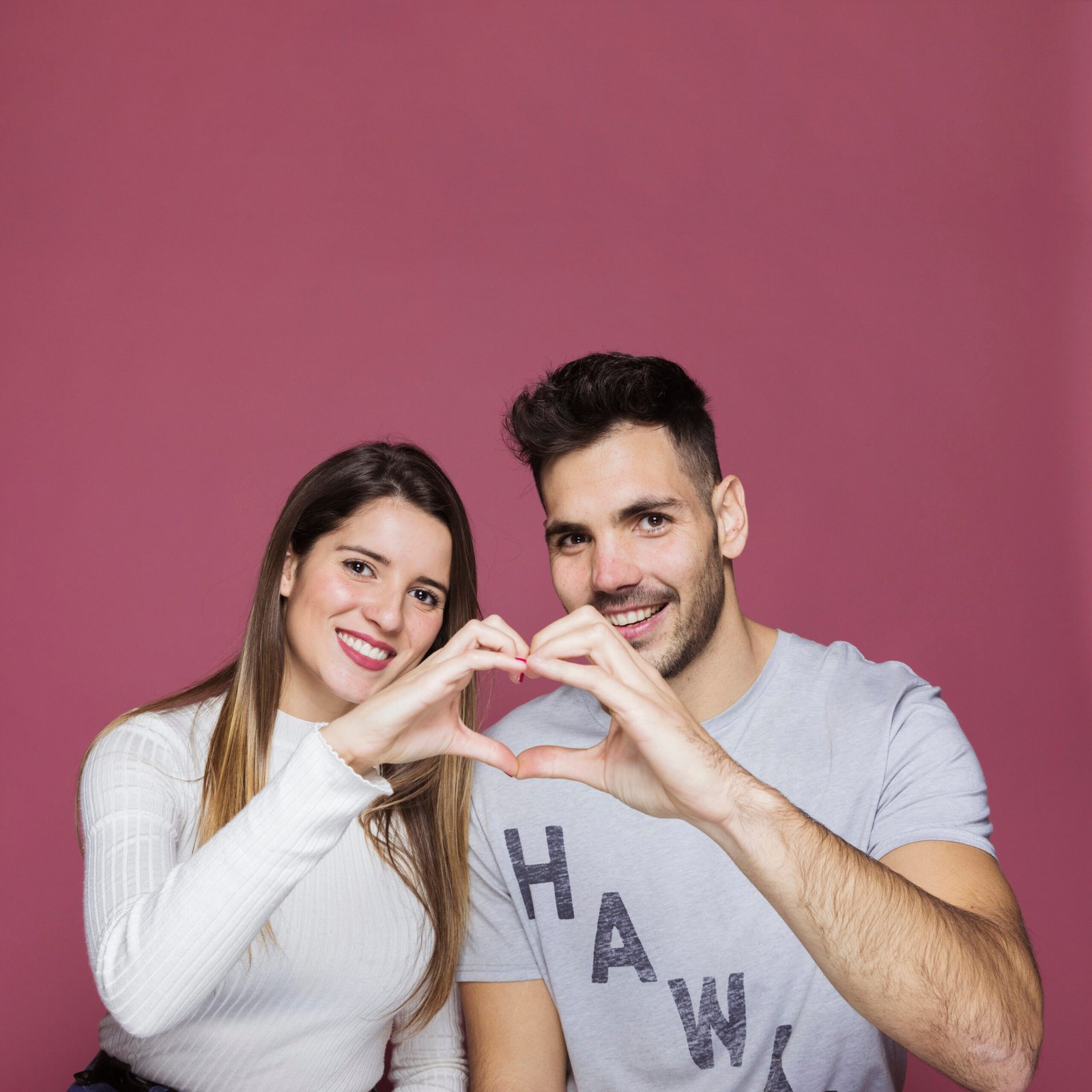 smiling-young-woman-man-showing-heart-by-hands